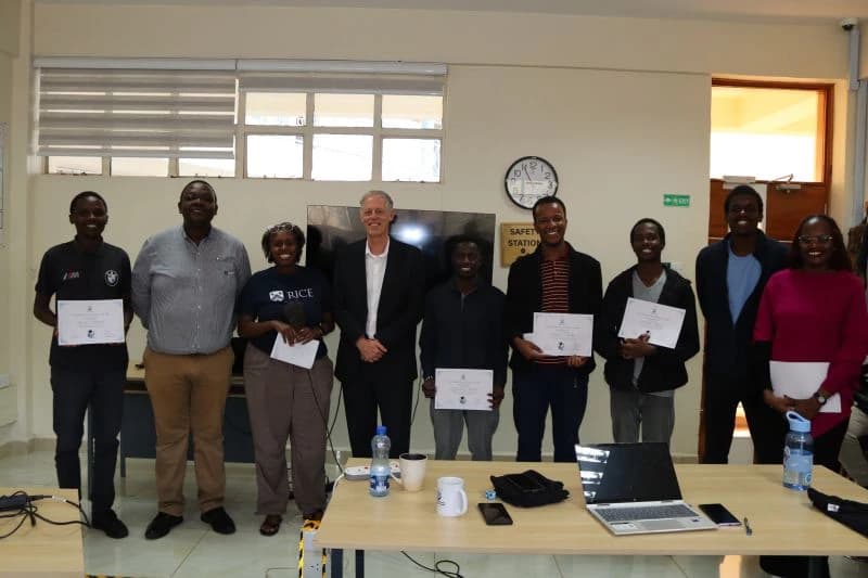 Winning team members holding certificates beside CDIE staff and guests