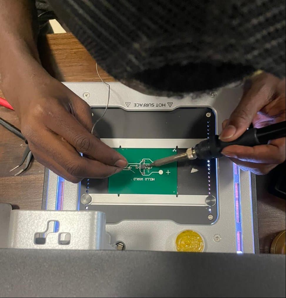 Hands soldering a circuit board