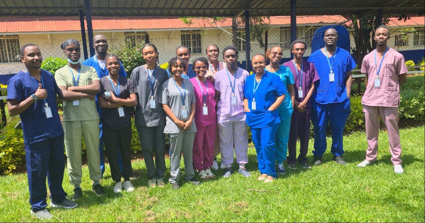 Summer program participants in scrubs outside a hospital
