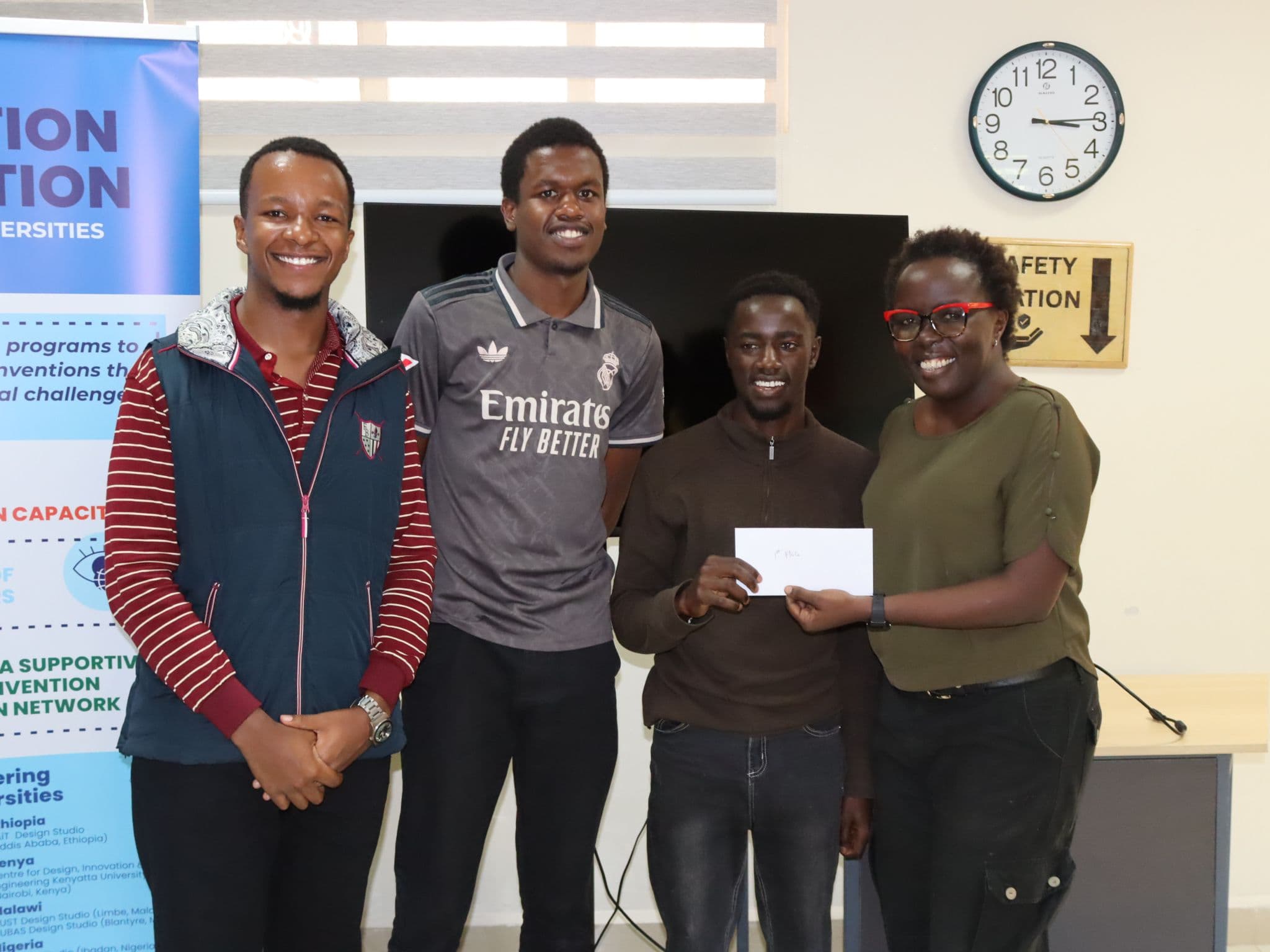 First-place team of three receiving their envelope from a CDIE staff member