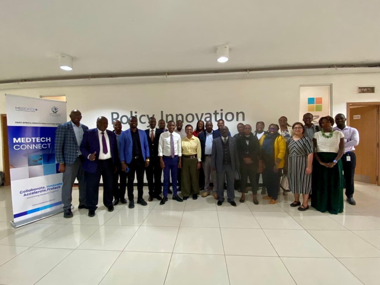 Participants of a MedTech Connect convening standing in front of event banners